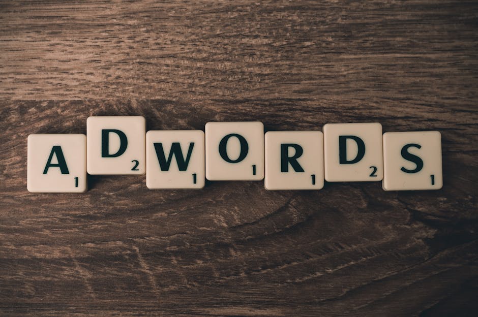 ask customers for referrals - Scrabble tiles spelling 'AdWords' on a wooden surface, symbolizing digital marketing concepts.