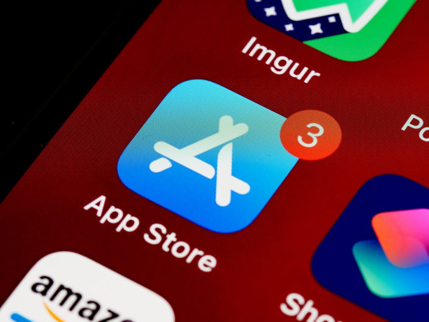 in-app referral patterns - Close-up of App Store icon on iPhone screen with notification badge, highlighting app updates.