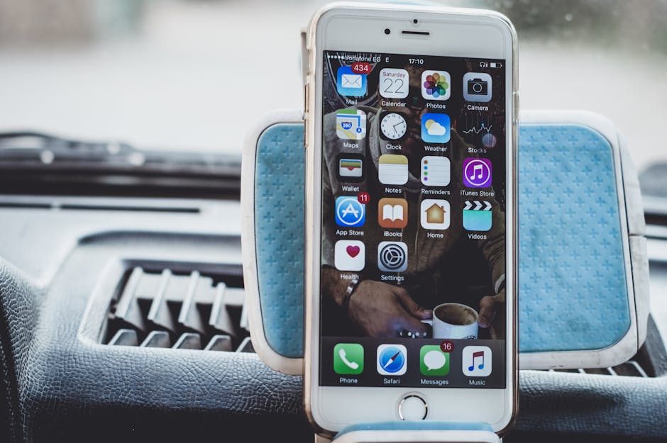 loyalty points program mechanics - Close-up of a smartphone mounted on a car dashboard showing home screen with apps.