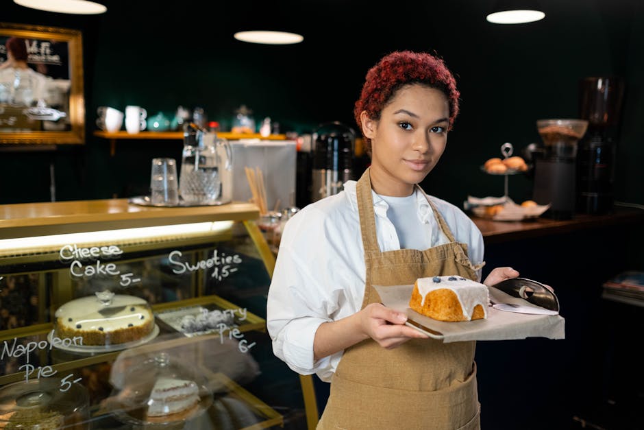 restaurant referral marketing - Young barista in a coffee shop holding a plate with a freshly served cake, ready to delight customers.