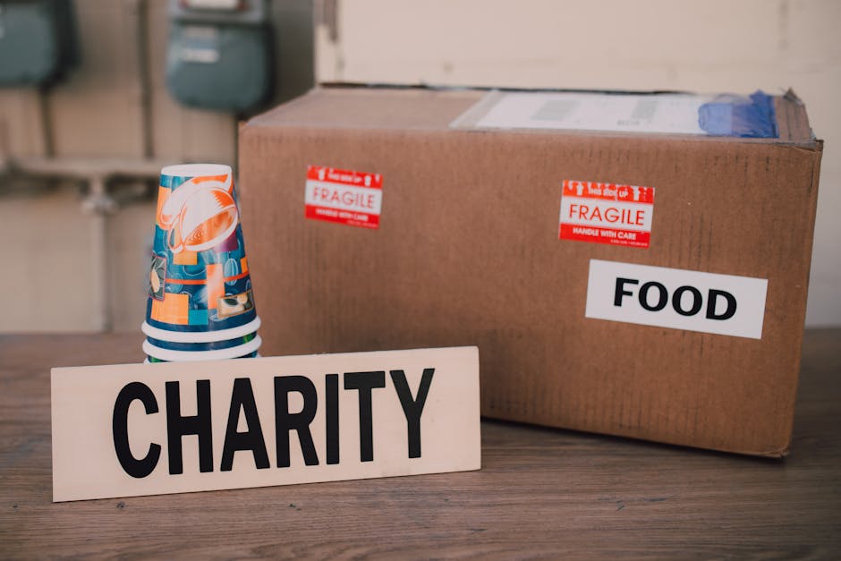 charity donation referral rewards - Image of a charity donation box filled with food supplies and paper cups.