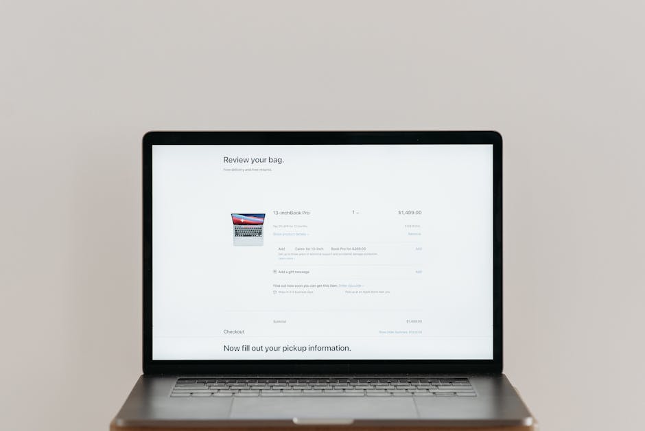 e-commerce referral program - Minimalist laptop showing an online checkout screen on a white background, ideal for tech context.