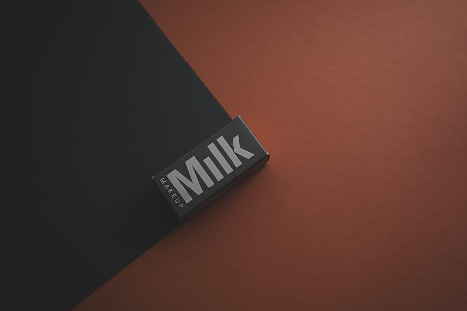 e-commerce referral program - Close-up of a Milk Makeup box on a dark background, showcasing minimalist packaging design.