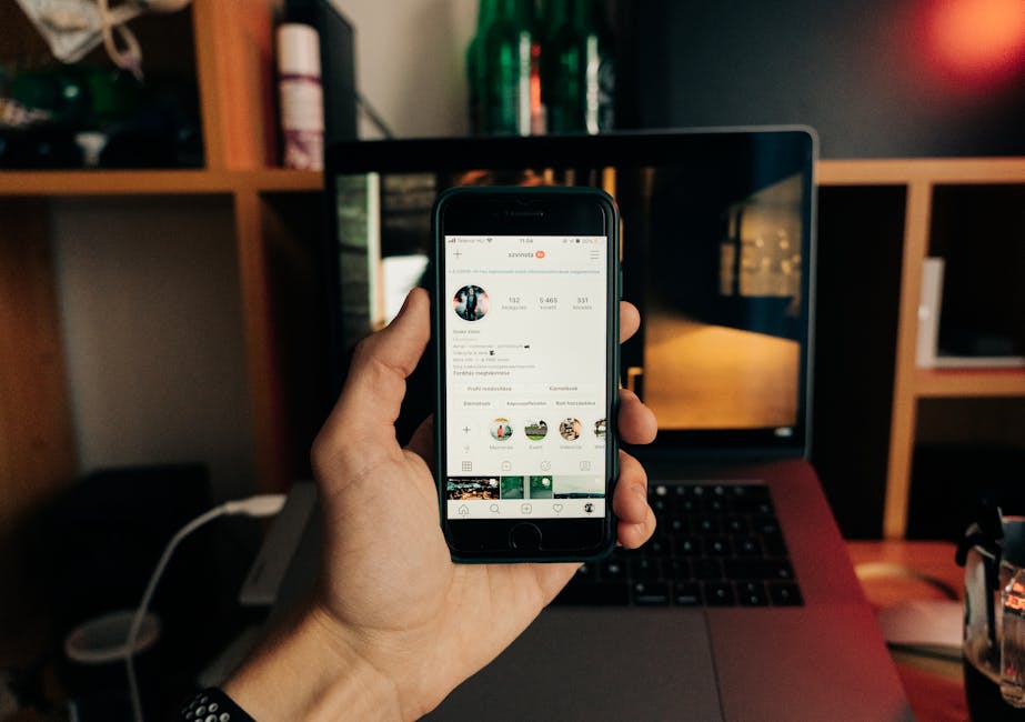 micro-influencer referral - Close-up of a hand holding a smartphone with Instagram open, showcasing technology in use.