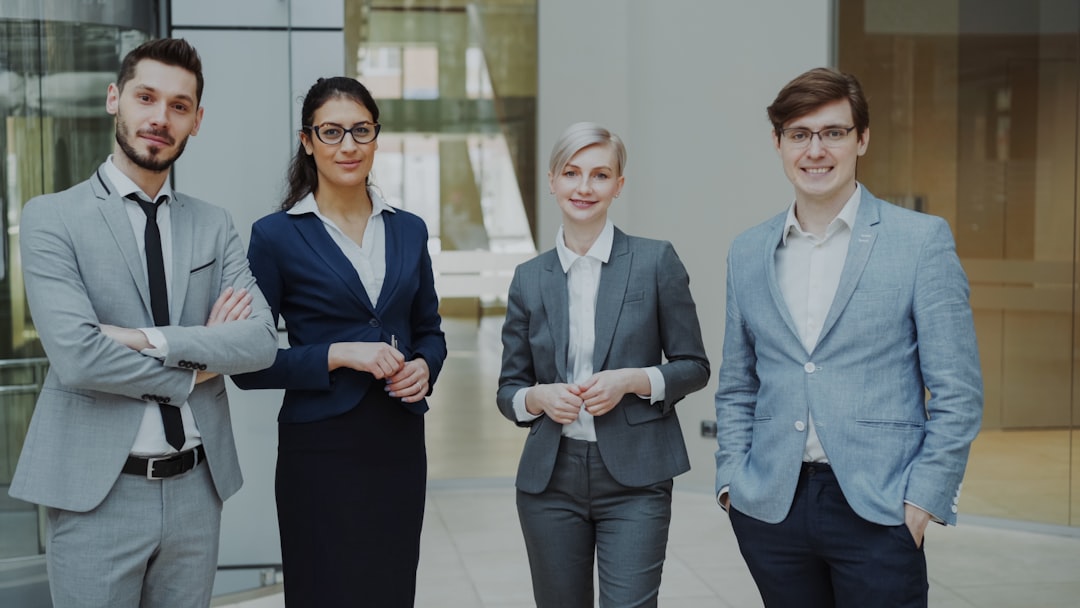 referral marketing news May 2026 - Four professionals in business attire stand together.