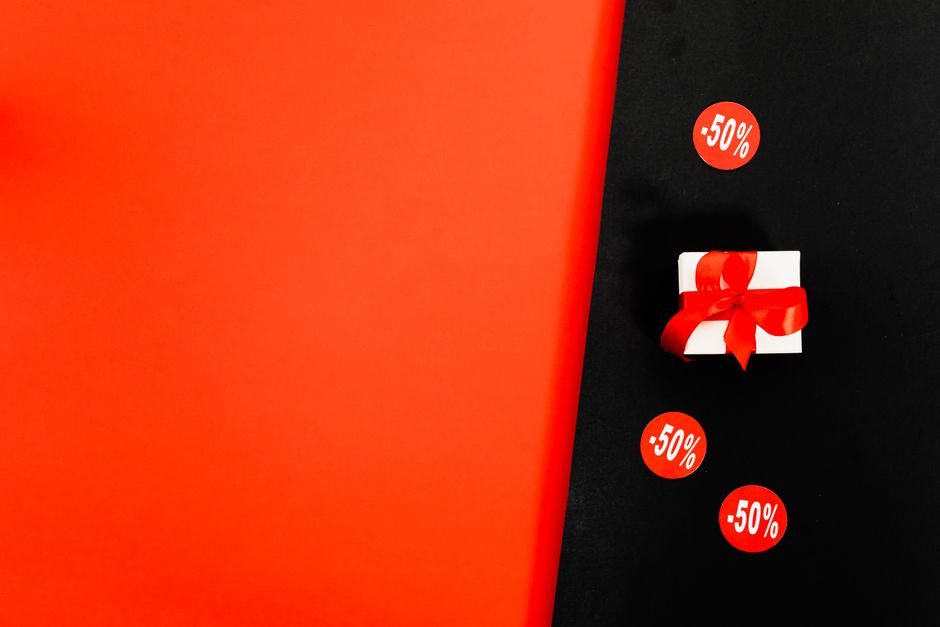 referral email subject lines - Shop 50% discounts with a stylish gift box on a Black Friday sale background.