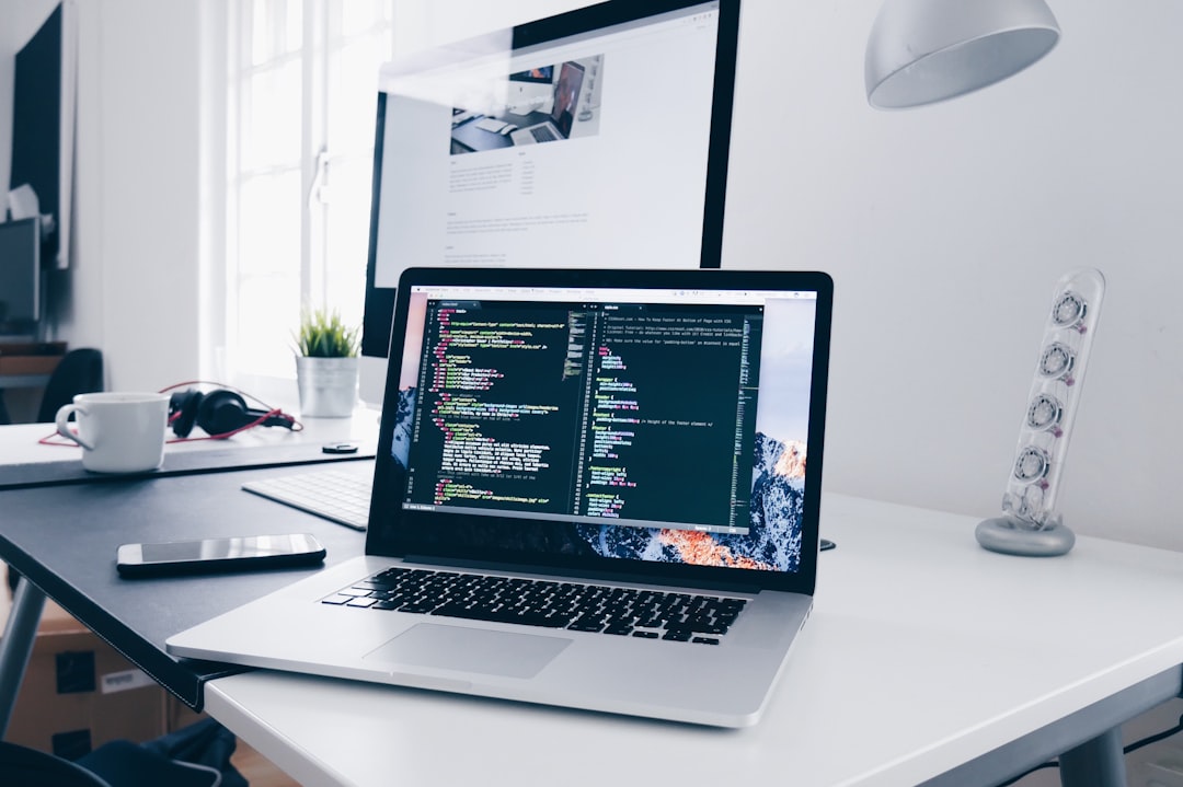 what can cloudways host - A MacBook with lines of code on its screen on a busy desk