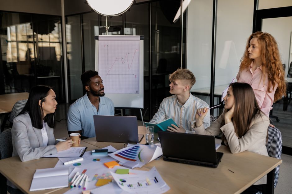 affiliate marketing news - A diverse team discussing business strategy around a conference table in a modern office.